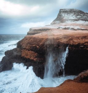 waves crash on a cliff